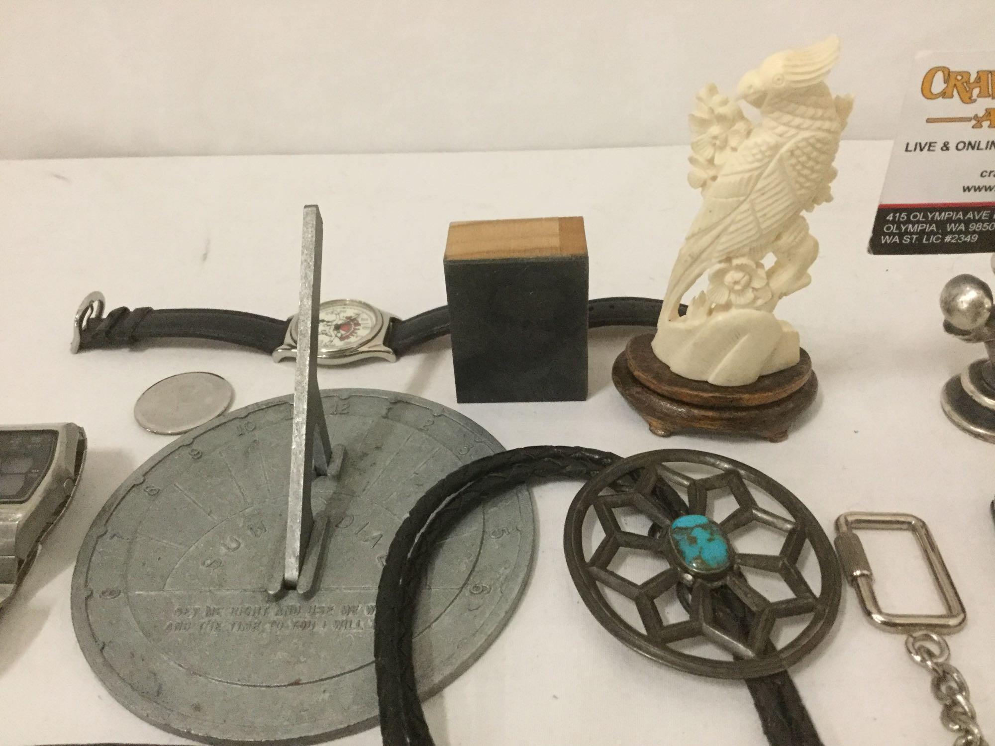 Large bag of mixed items: pocket knife, belt buckles, watches, sun dial & more