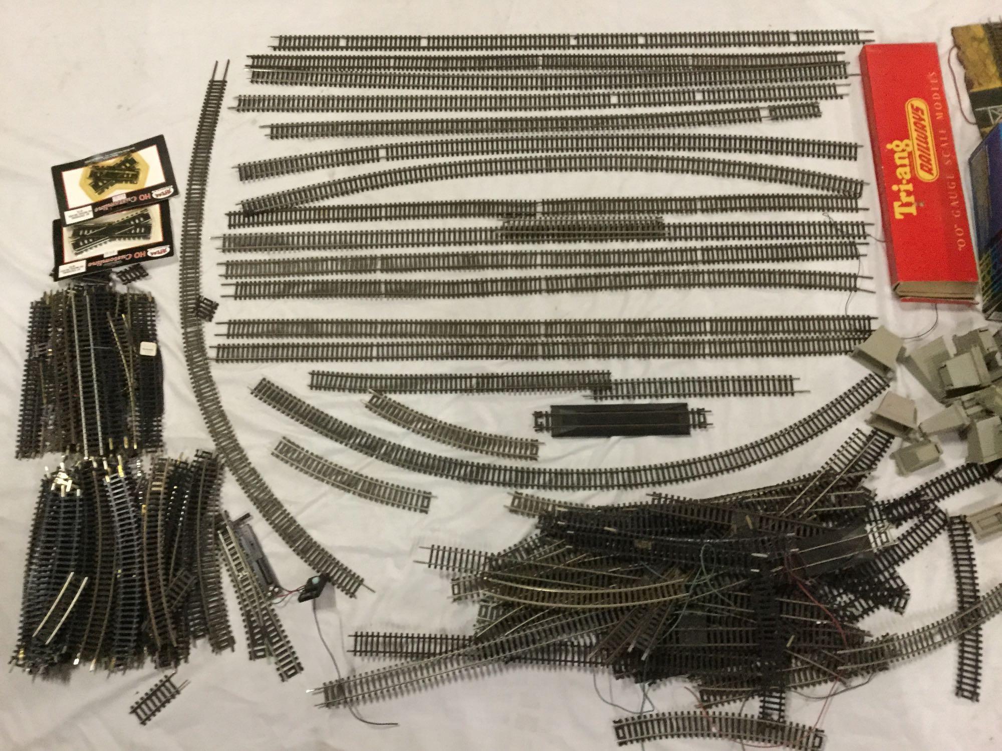 Collection of HO scale model train tracks, train cars, MRC Model Train Controller and accessories