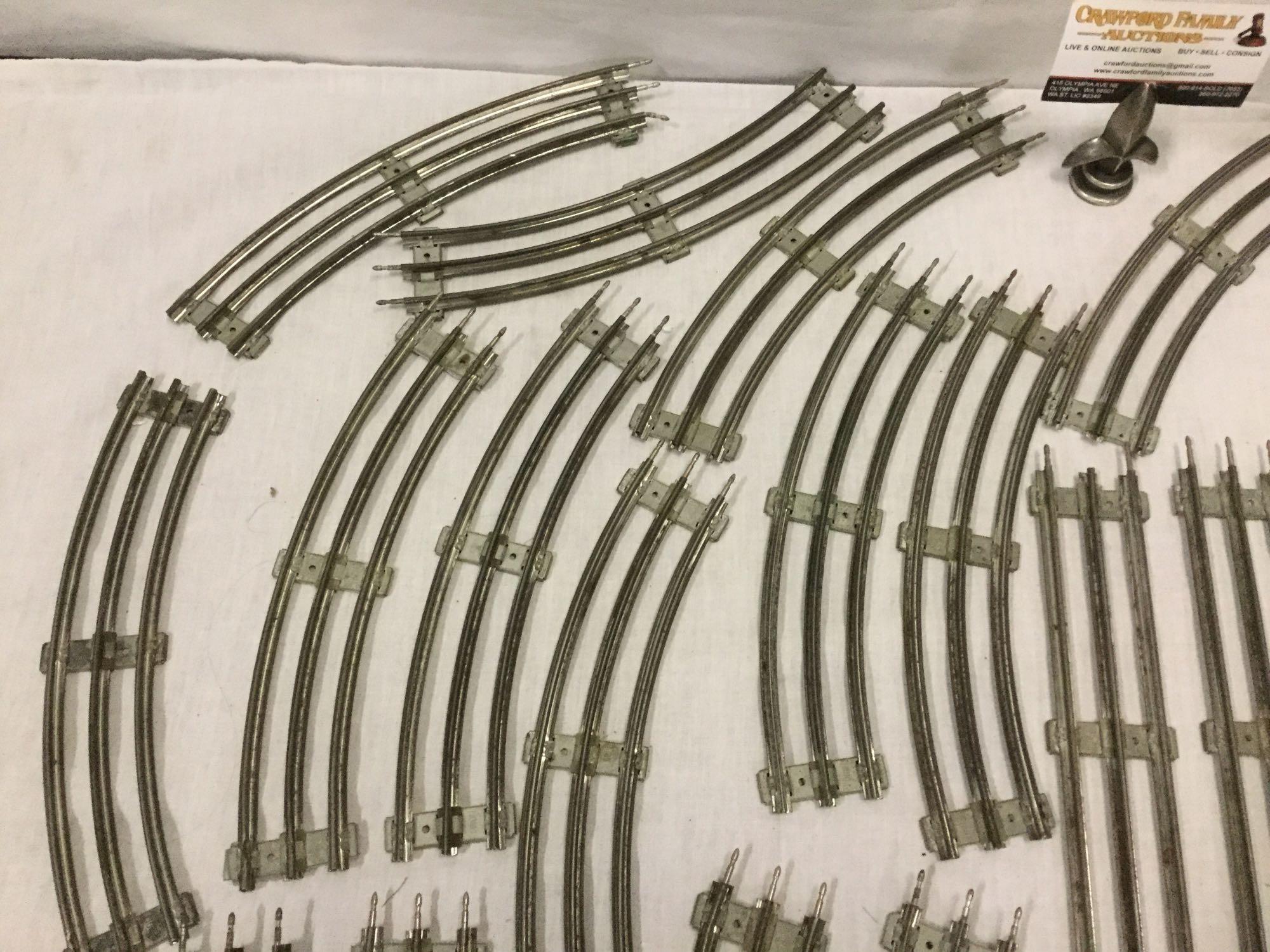 Collection of model train tracks with switcher and transformer base