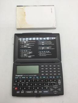 Polaroid 5kb electronic organizer with manual. Needs battery SOLD AS IS