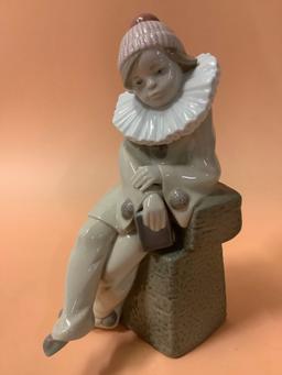 Lladro figurine of sitting boy dressed as jester, Daisa 1983, hand made in Spain, marked: C-16.