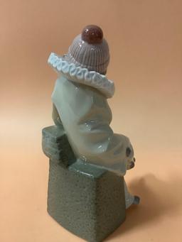 Lladro figurine of sitting boy dressed as jester, Daisa 1983, hand made in Spain, marked: C-16.