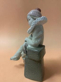 Lladro figurine of sitting boy dressed as jester, Daisa 1983, hand made in Spain, marked: C-16.