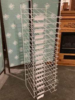 White metal wire retail paper rack, approx. 12 x 12 x 42 inches.