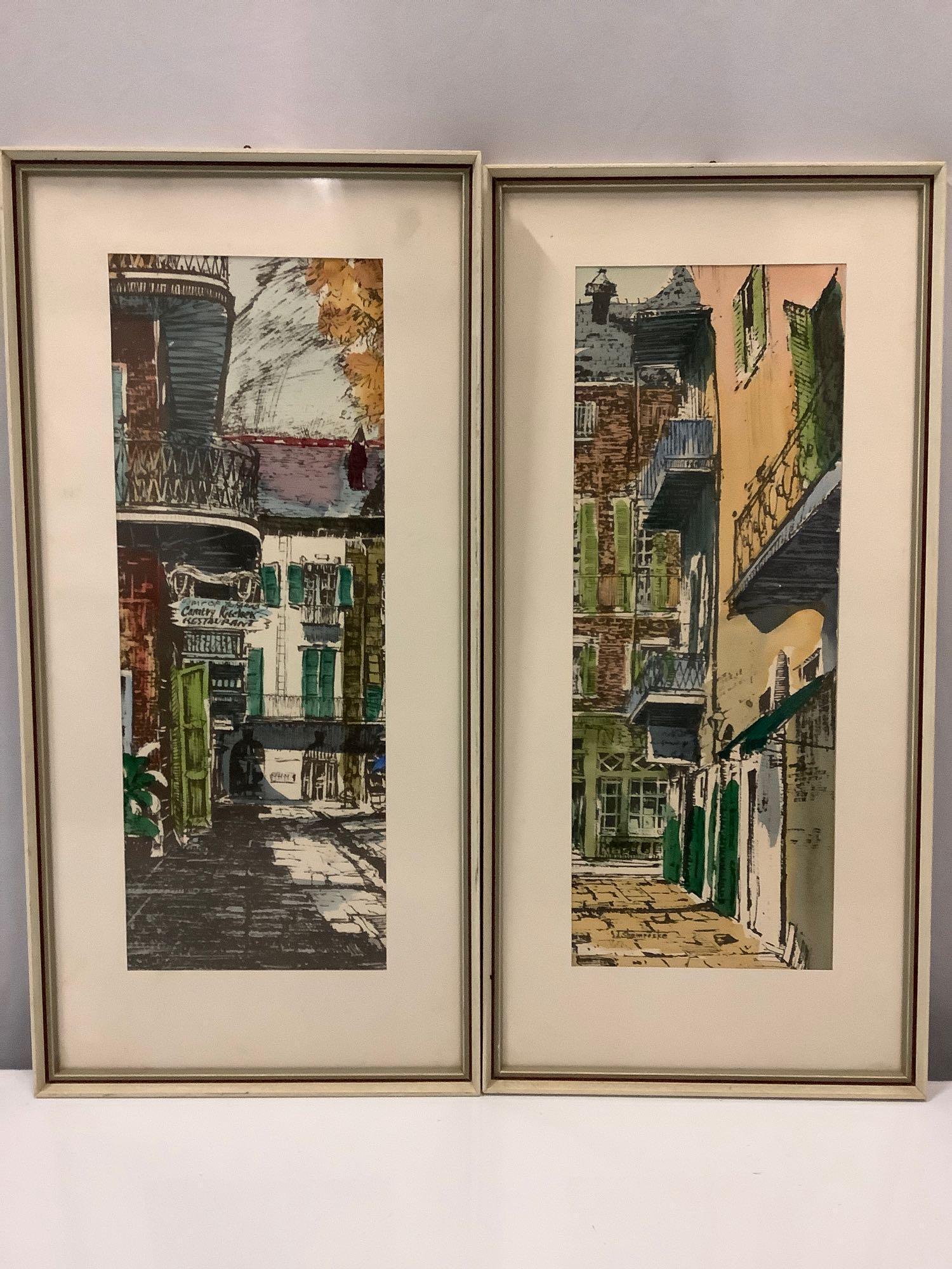 2 framed street scene watercolor art prints by Shemroske, approx. 9.5 x 19.5 in.