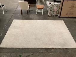 Shag carpet, off white, approx 73 x 109 in. Shows minor wear.