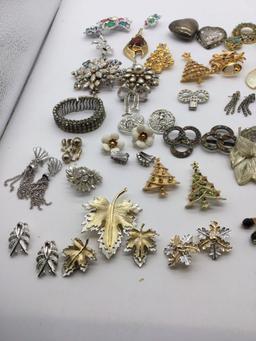 Large selection of vintage earrings, scarf holders, and broaches some signed