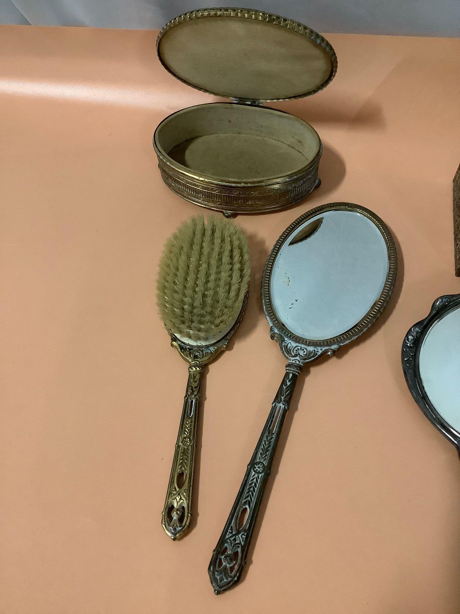 9 pc. lot of antique vanity items; hand mirrors, hair brushes, comb, tissue box cover