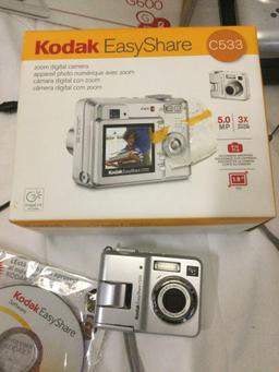 Lot of KODAK Easy Share C533 Digital Cameras plus printer docks. Sold as is.