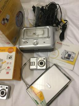 Lot of KODAK Easy Share C533 Digital Cameras plus printer docks. Sold as is.