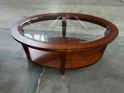 Elegant solid wood oval shaped coffee table with beveled glass top