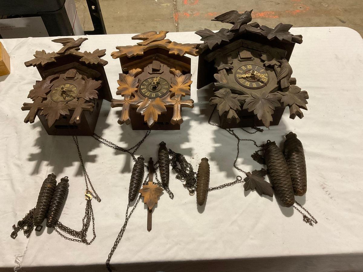 Set of three different size German Black Forest cuckoo clocks w/ weights, sold as is