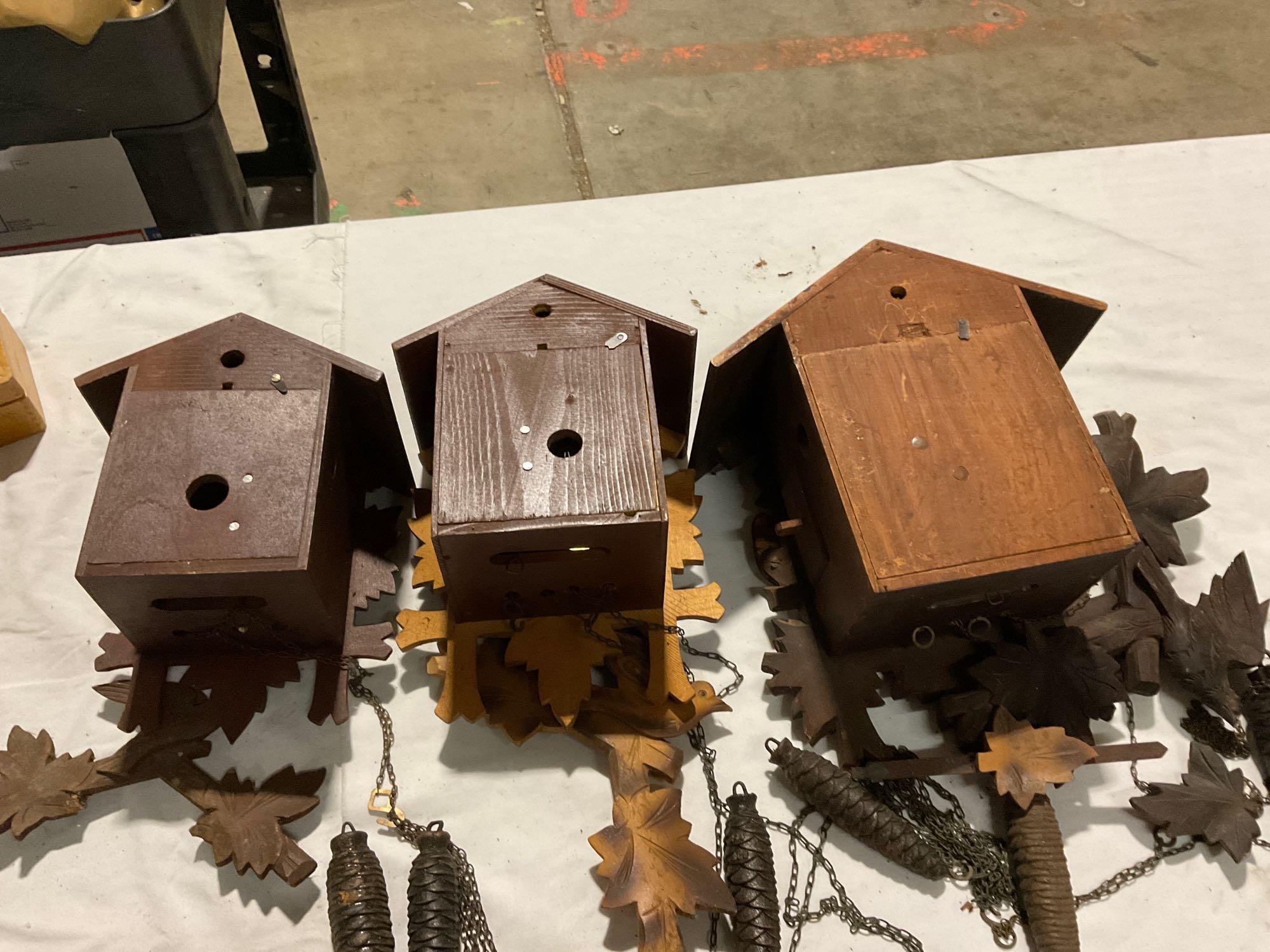 Set of three different size German Black Forest cuckoo clocks w/ weights, sold as is