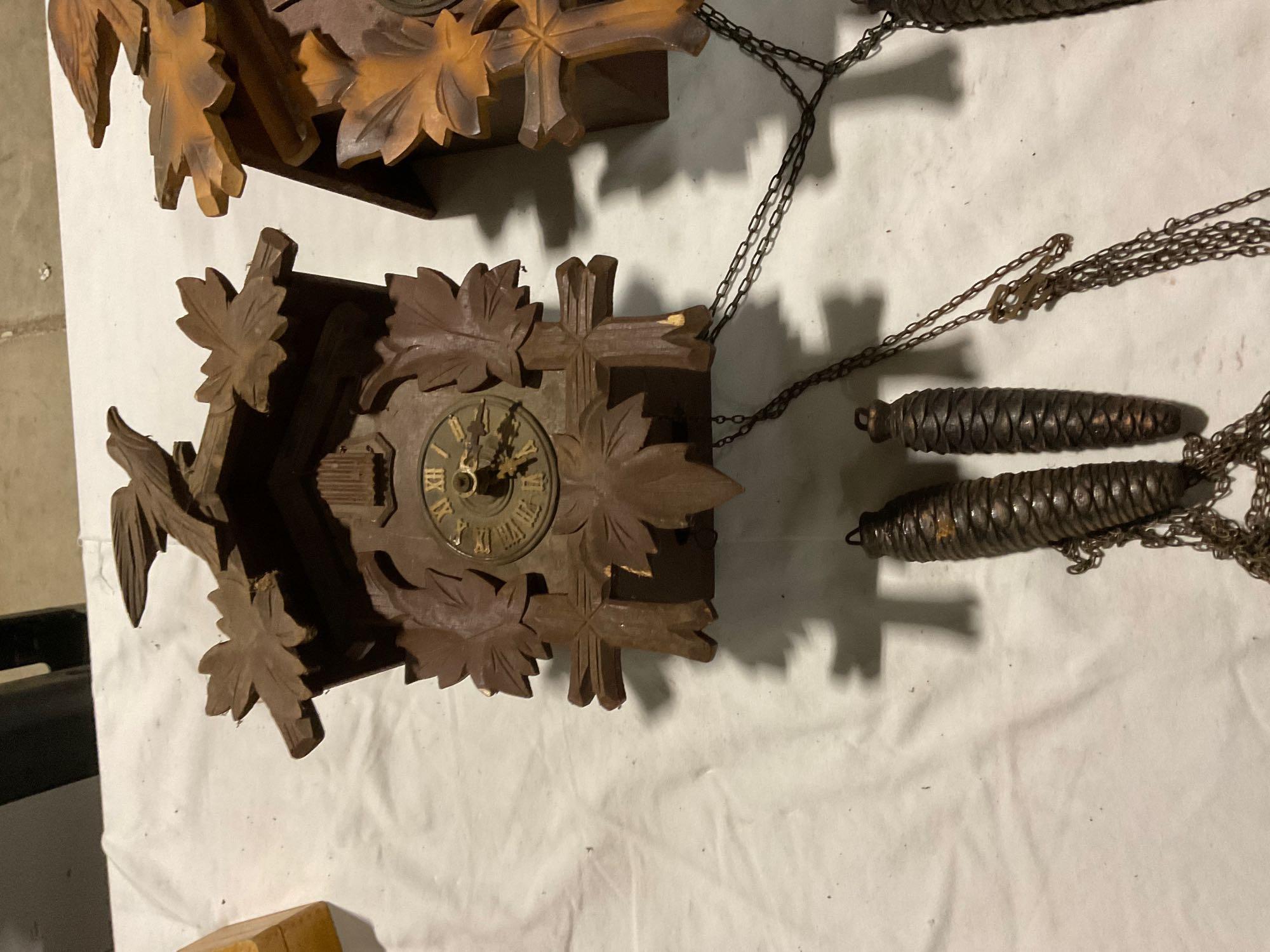 Set of three different size German Black Forest cuckoo clocks w/ weights, sold as is