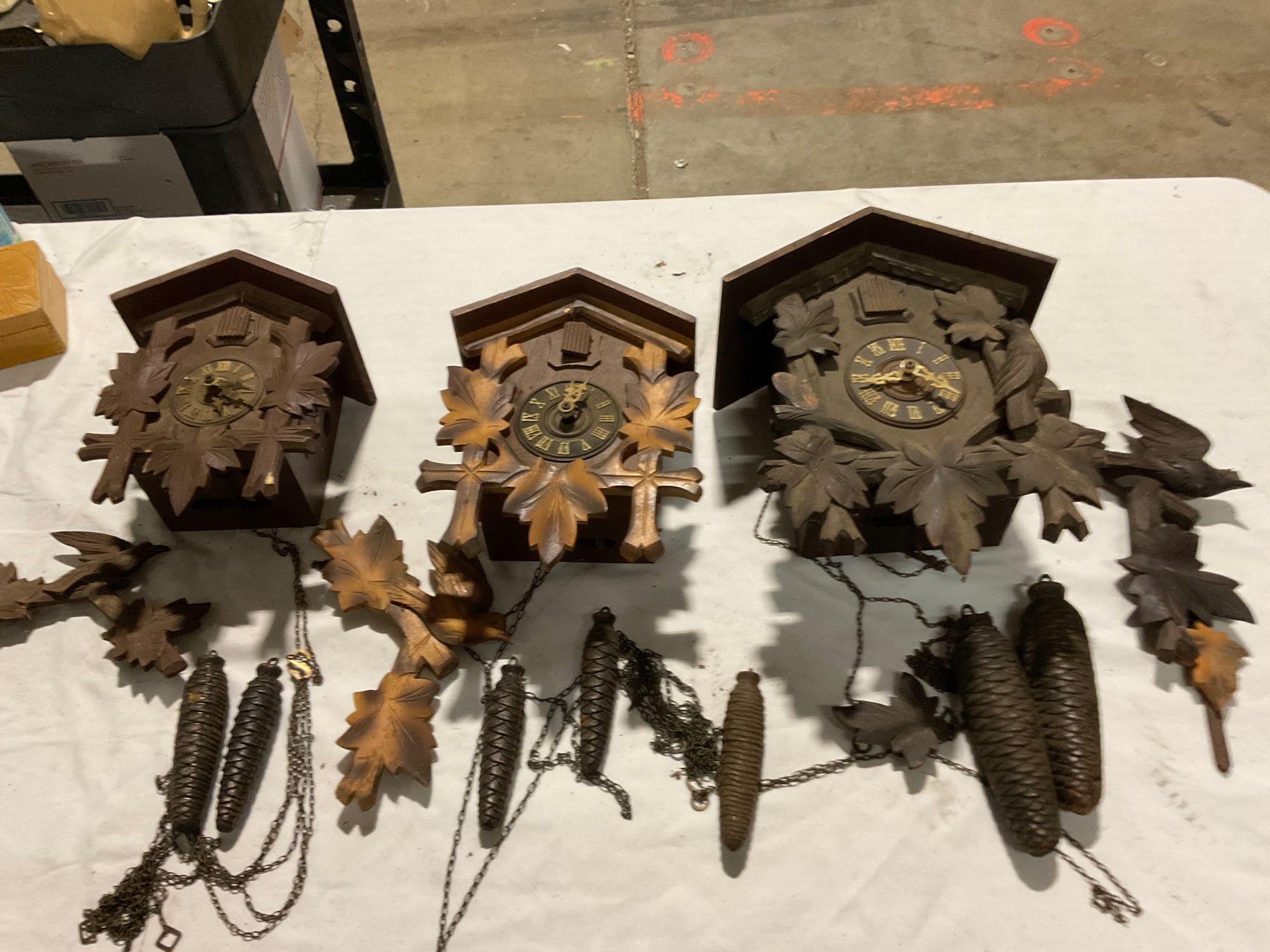 Set of three different size German Black Forest cuckoo clocks w/ weights, sold as is