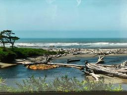 Framed color photograph of NorthWest coast beach scene, approx 31 x 22 in.