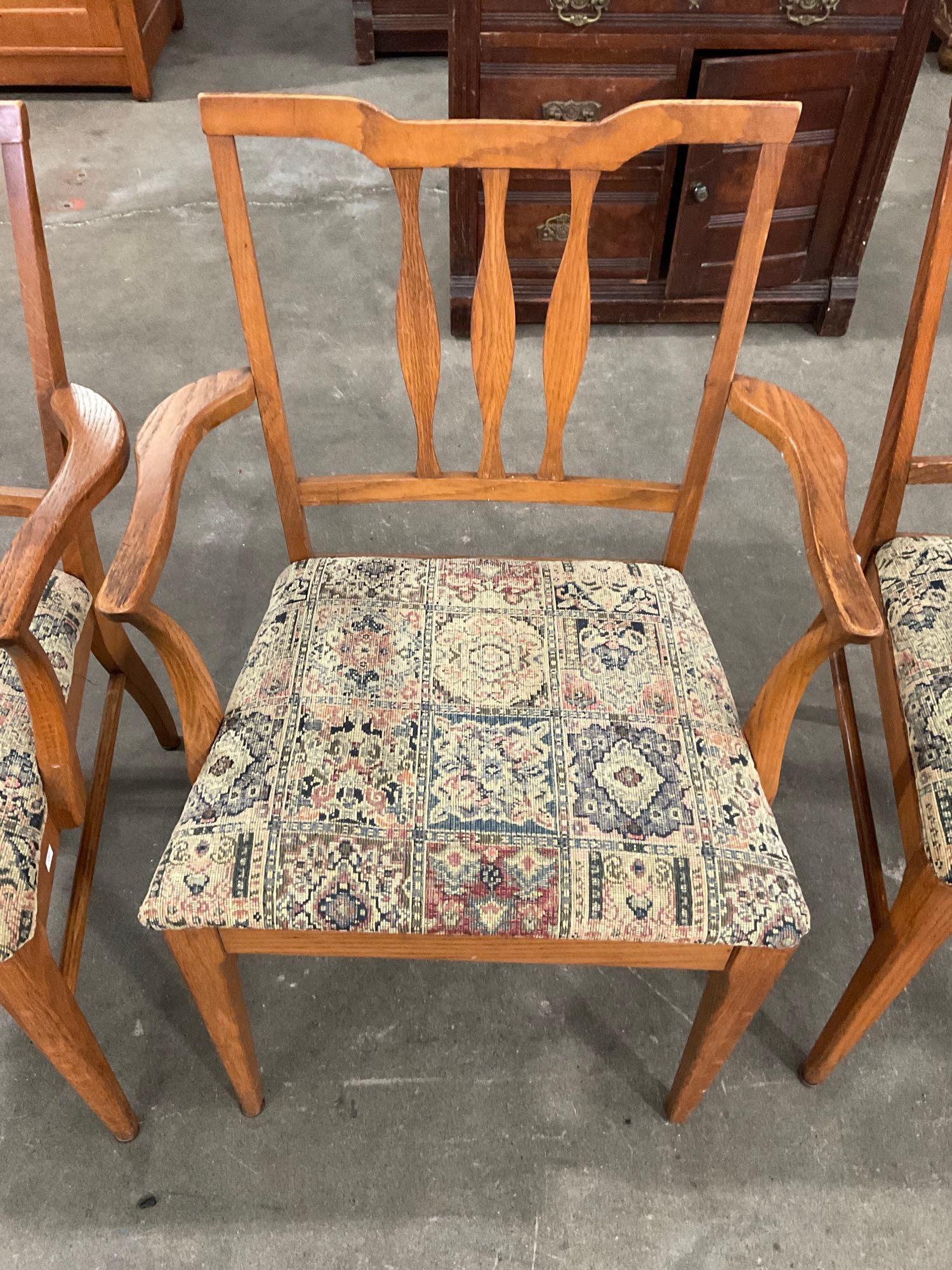 Set of 4 Oak Chairs with woven floral design seat cushions.