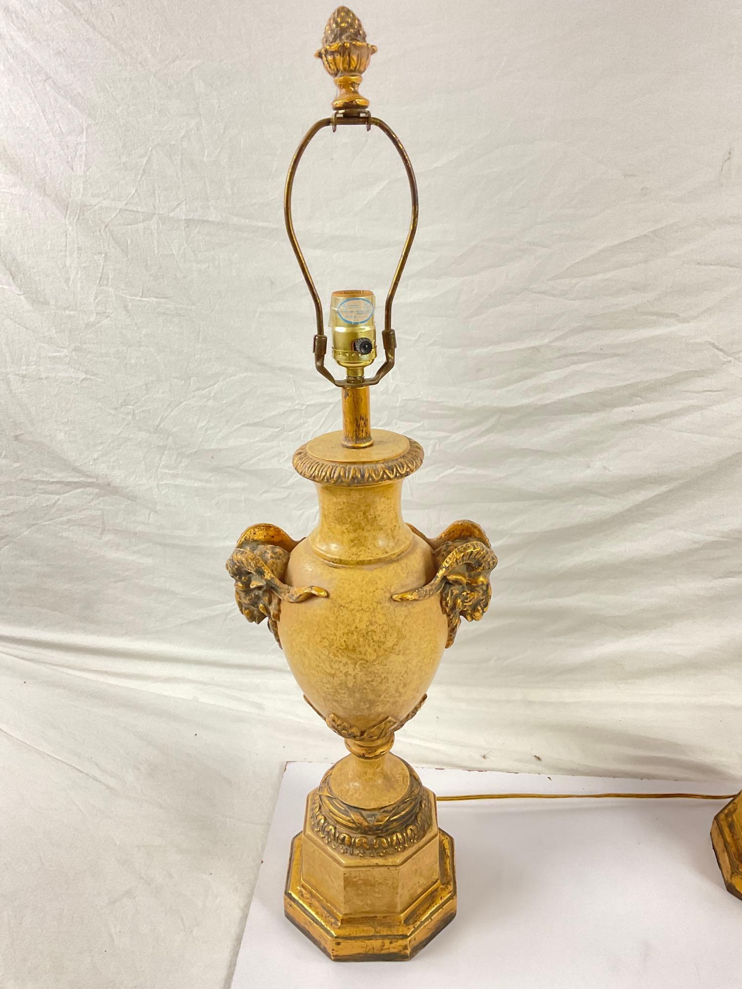 Pair of gold stone lamps with ram head accents