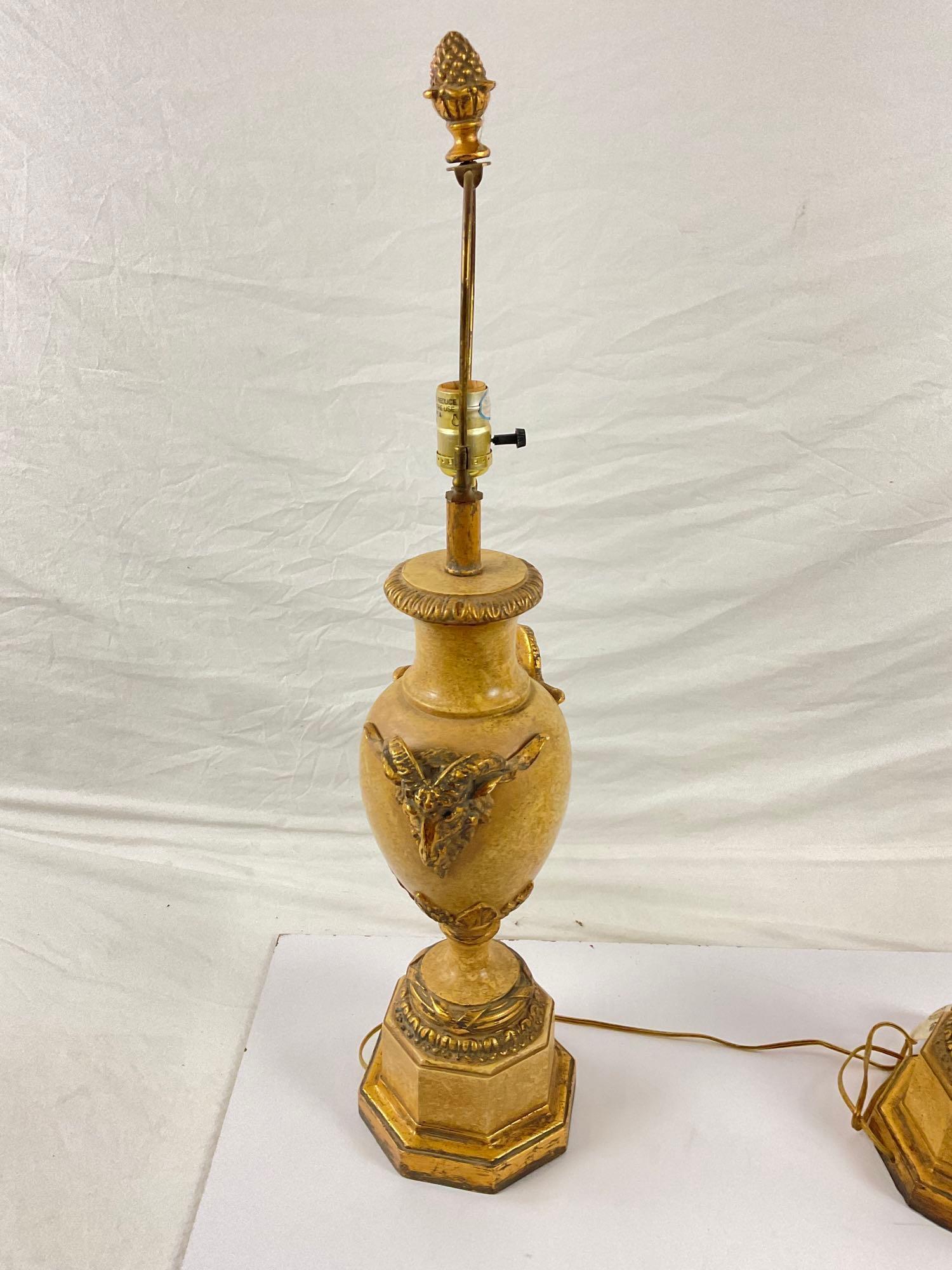 Pair of gold stone lamps with ram head accents