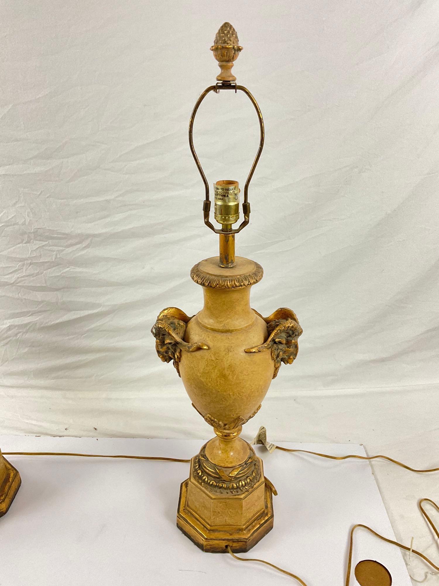 Pair of gold stone lamps with ram head accents