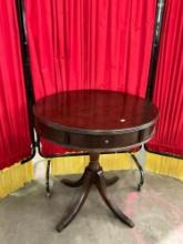 Antique round mahogany table w/ drawer and carved arched legs