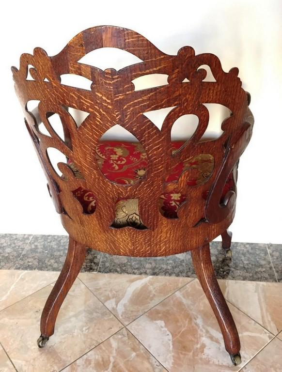 ANTIQUE AMERICAN OAK CHAIR WITH RED/GOLD PRINT ON CASTERS