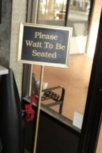 "Please Wait  To Be Steated" Sign