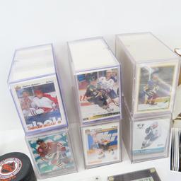 Collectible hockey cards and hockey pucks.