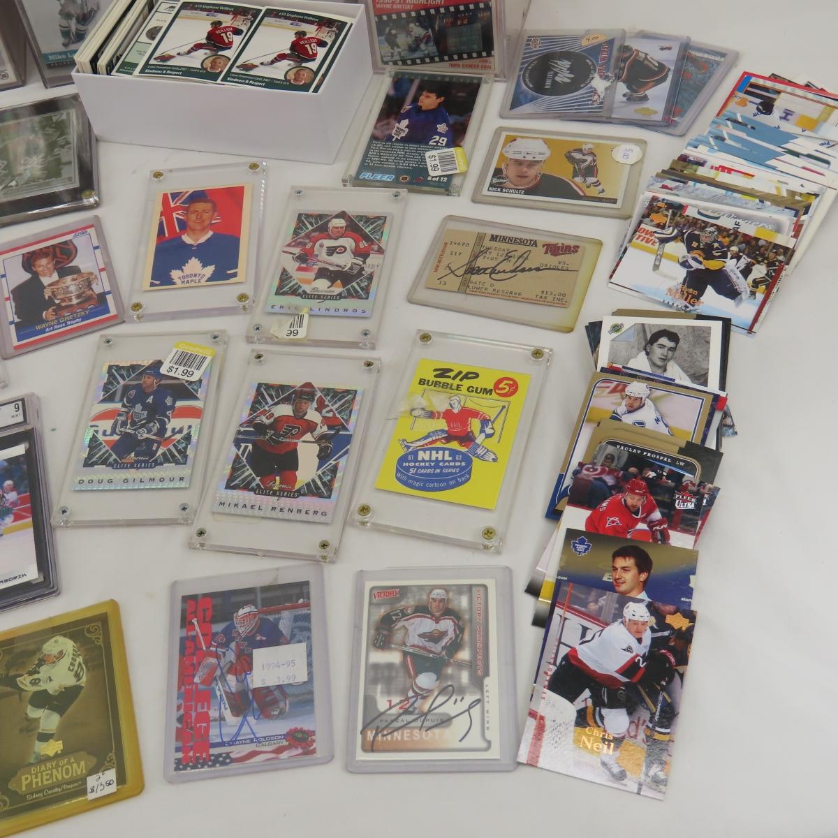 Collectible hockey cards and hockey pucks.