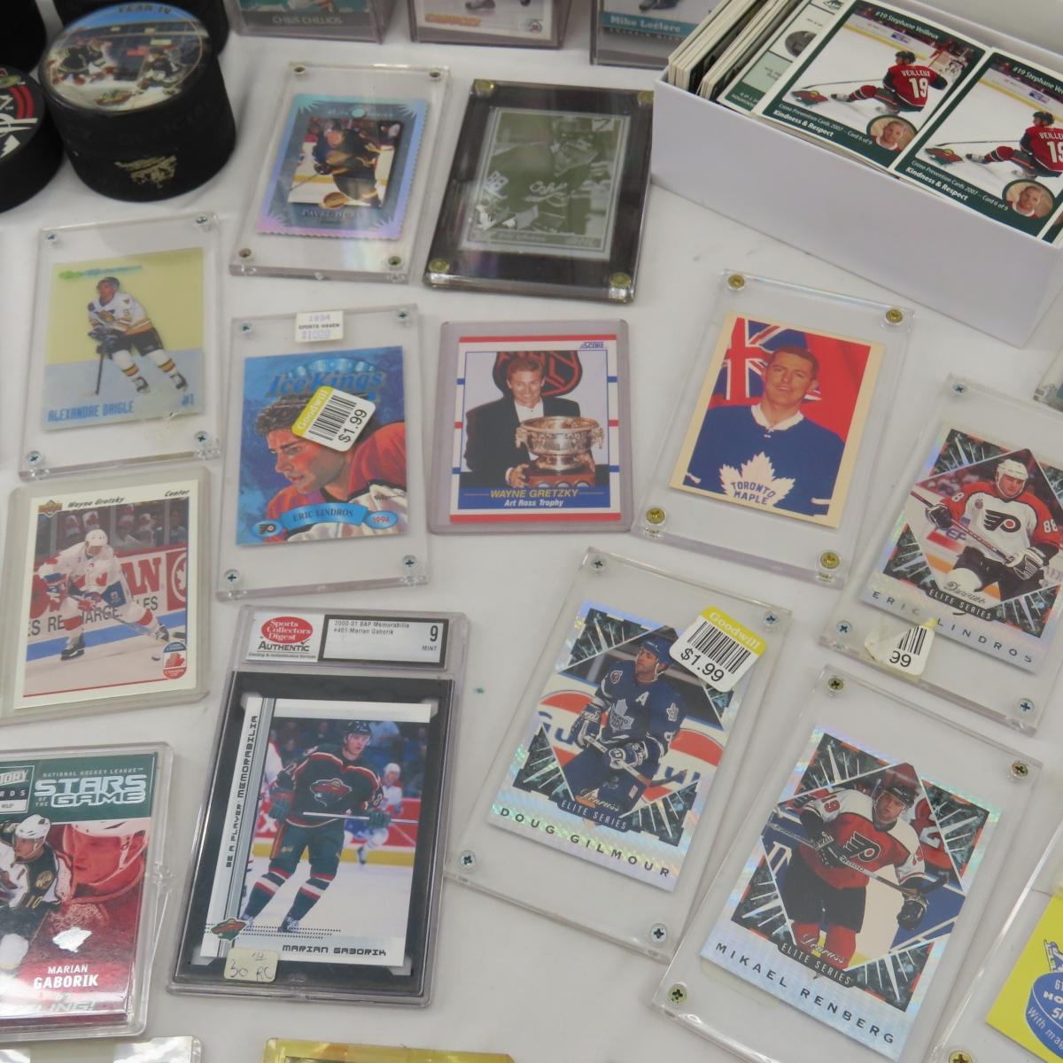 Collectible hockey cards and hockey pucks.