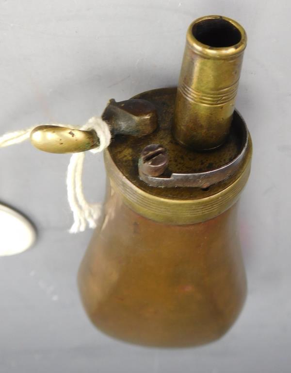 Lot #233 - (2) Small Civil War era brass powder flasks (1) plain, (1) paneled (approx 4”  each)