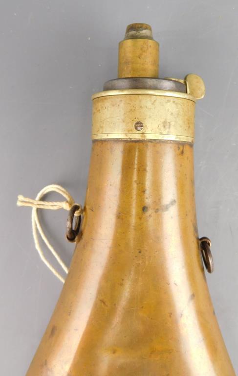 Lot #290 - (2) Antique powder flasks to include: Antique brass paneled powder flask with  hanging