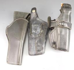 Lot #39 - (3) Leather Pistol Holsters, (1) leather belt mount hand cuff holder, (1)  Galls Gear