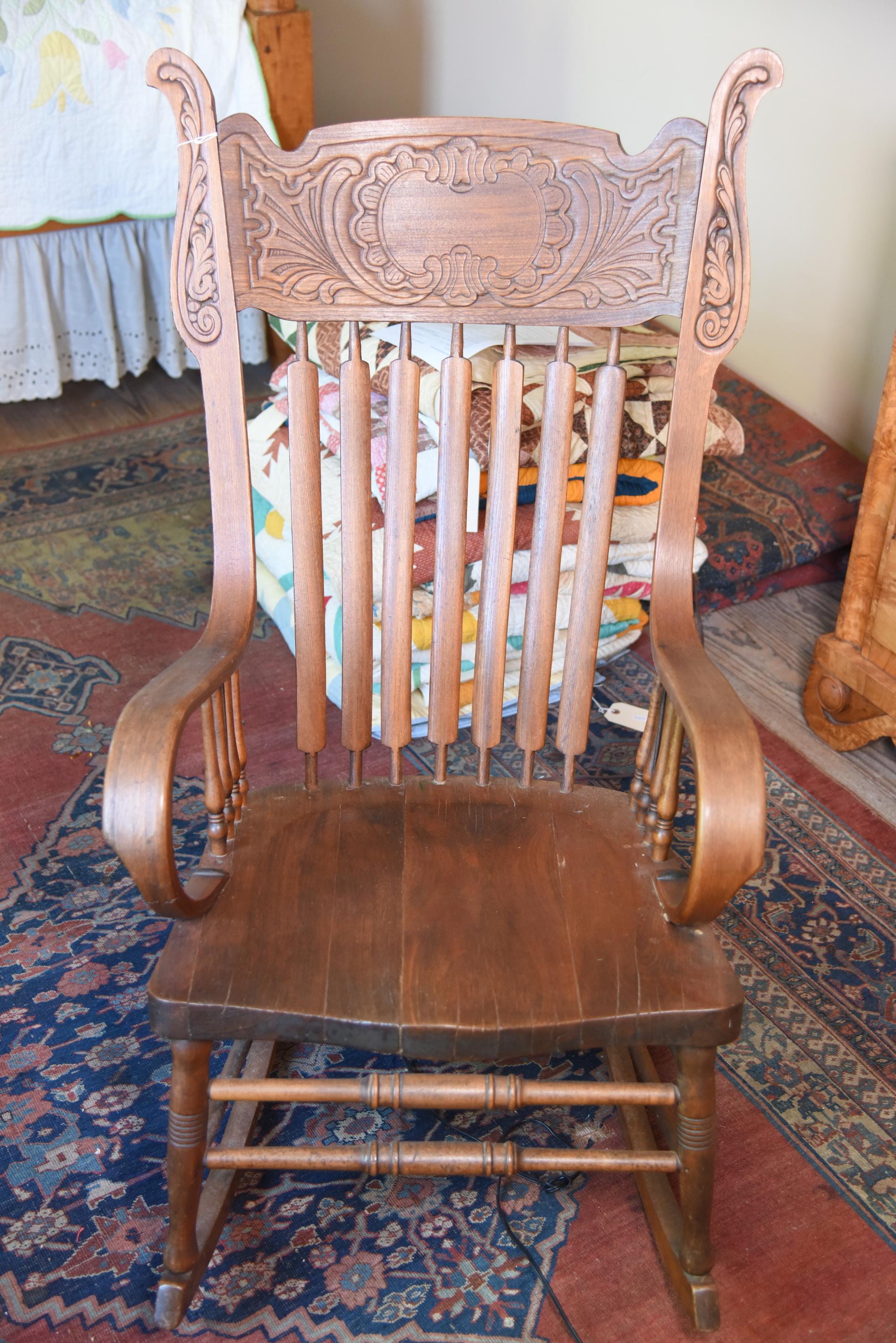 Lot #534 - Late 19th Century Oak pressed slat back open arm rocker with scrolled arms and plank