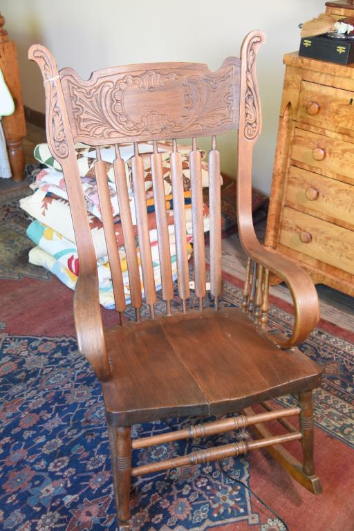 Lot #534 - Late 19th Century Oak pressed slat back open arm rocker with scrolled arms and plank