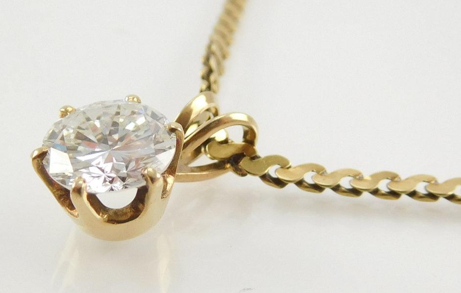 Lot #11: 14k yellow gold ladies 6 prong solitaire diamond pendant, containing a brilliant cut