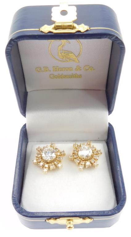 Lot #14: 1 pair of 14k yellow gold ladies 4 prong solitaire pierced earrings, each containing a