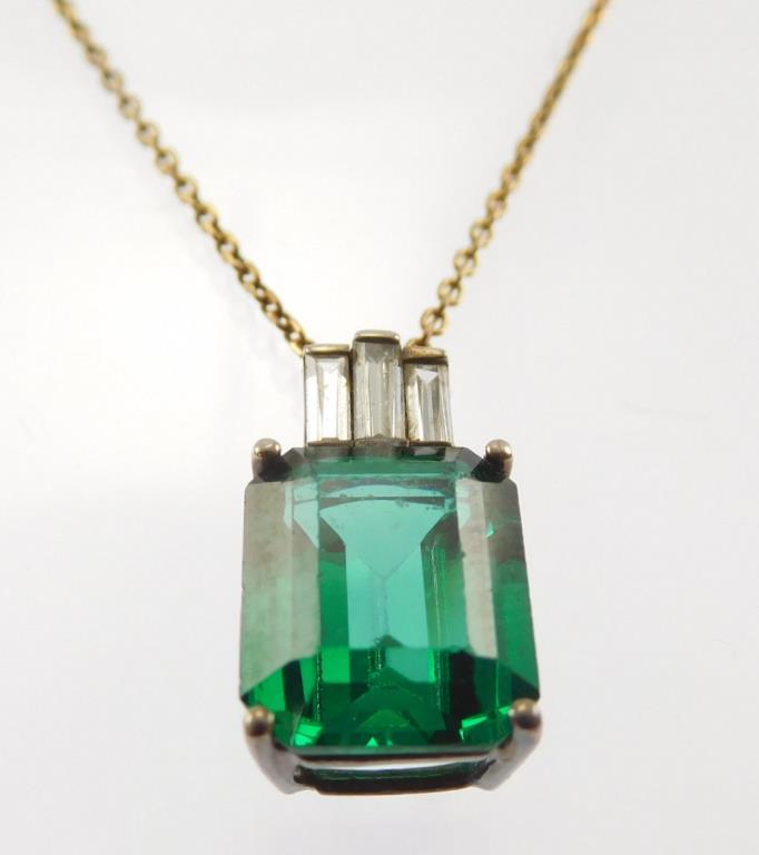 Lot #4: Sterling silver ladies 4 Prong pendant containing: a medium green rectangular synthetic