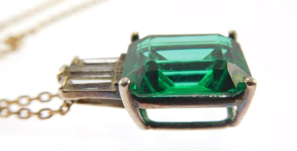 Lot #4: Sterling silver ladies 4 Prong pendant containing: a medium green rectangular synthetic