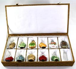 Collection of 11 Oriental snuff bottles in a plush hinged case