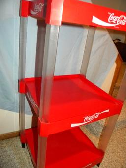 Coca Cola= Three Tier Plastic Organizer Stand.