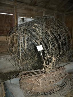 Two Rolls Of Used Barb Wire; Two Rolls Woven Wire.