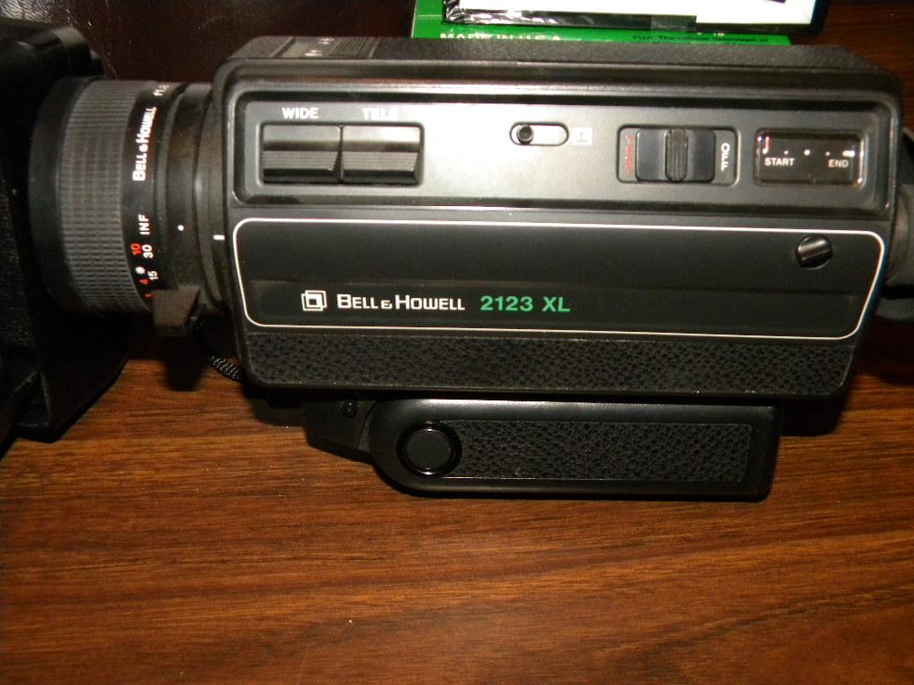 Bell And Howell 2123 El W/camera And Case; Pentax Ioz 35 Mm Camera W/case;