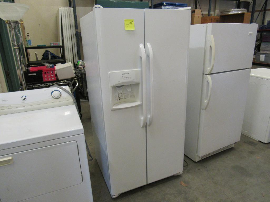 Frigidaire side by side refrigerator/freezer Mdl FFHS2311LWRA. with ice maker, water and ice in the