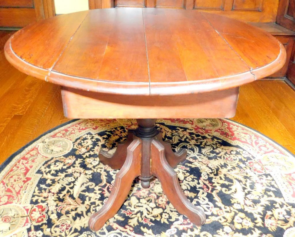 Double Drop-leaf Round Pedestal Table