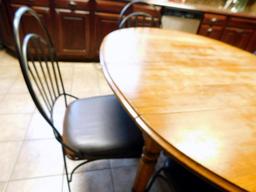 Wooden Dining Table with Four Black Metal Chairs