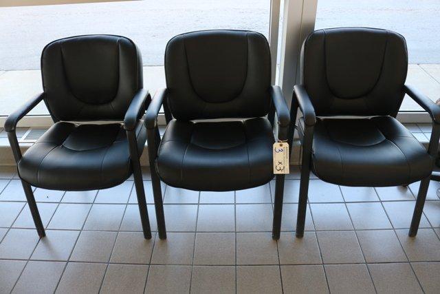 3 black vinyl office chairs - as is