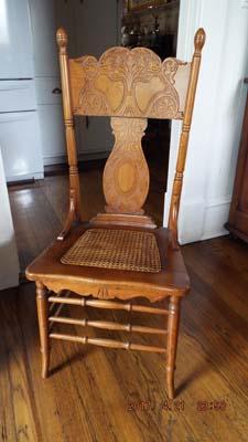 Four pressed oak chairs with wicker bottoms