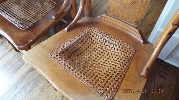 Four pressed oak chairs with wicker bottoms