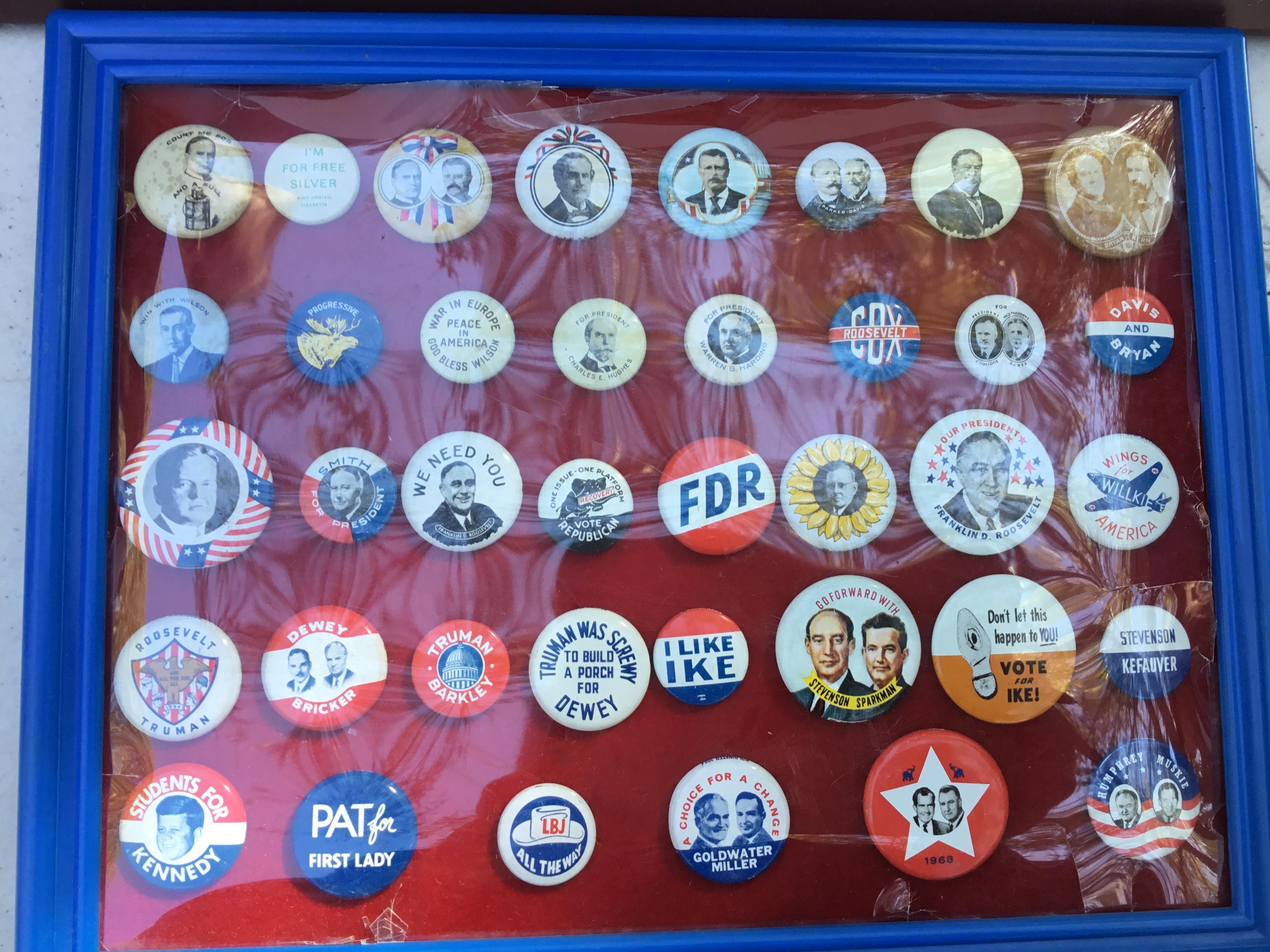 Group of Presidential buttons in a plastic frame; 38 total buttons